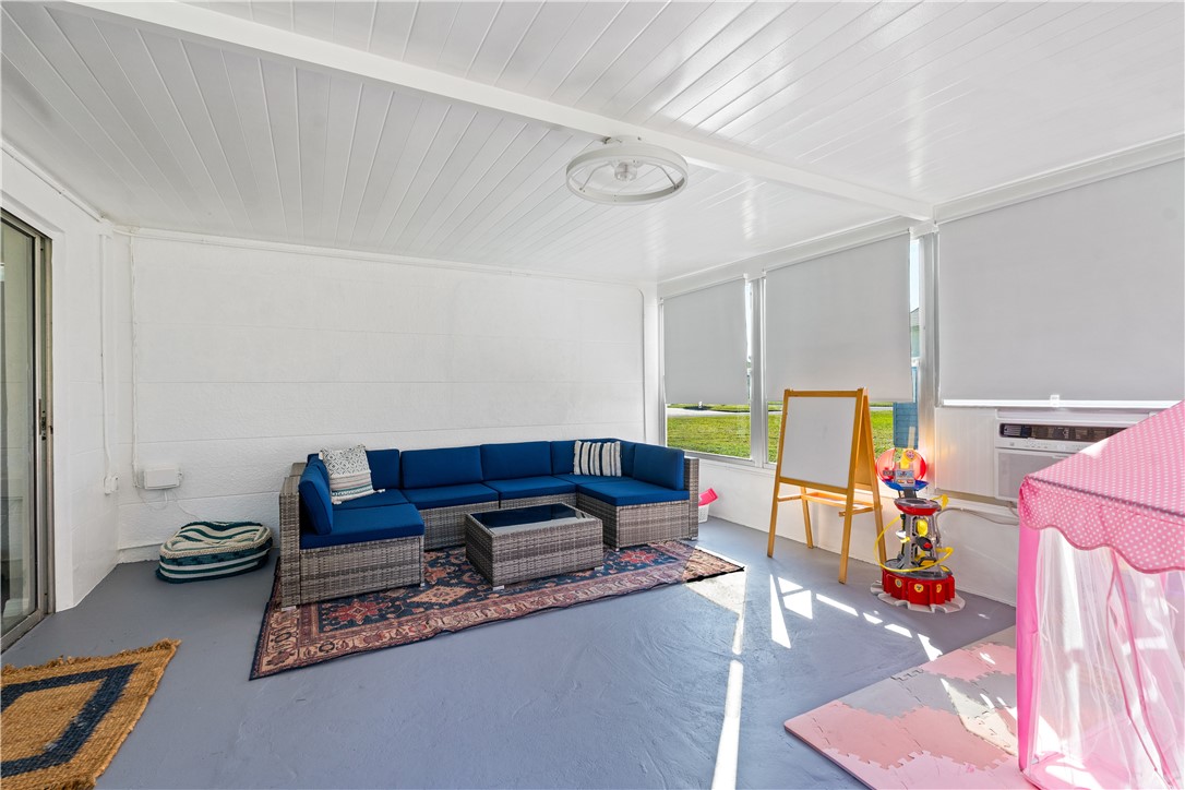1621 5th Avenue Vero Beach, FL 32960 - Photo 19 of 35 a living room with furniture a rug and gym equipment