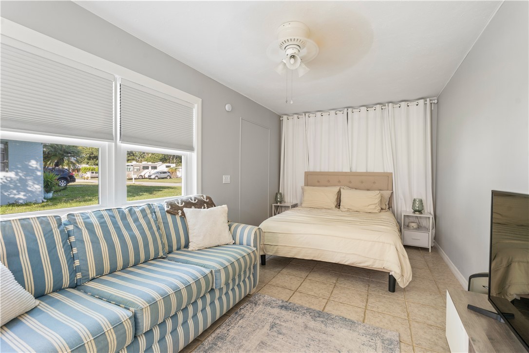 1621 5th Avenue Vero Beach, FL 32960 - Photo 26 of 35 a bedroom with a large bed and a couch