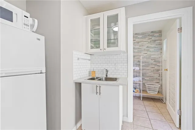 a kitchen with stainless steel appliances granite countertop a sink and a refrigerator