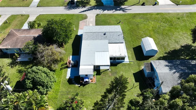 an aerial view of house with yard swimming pool and outdoor seating