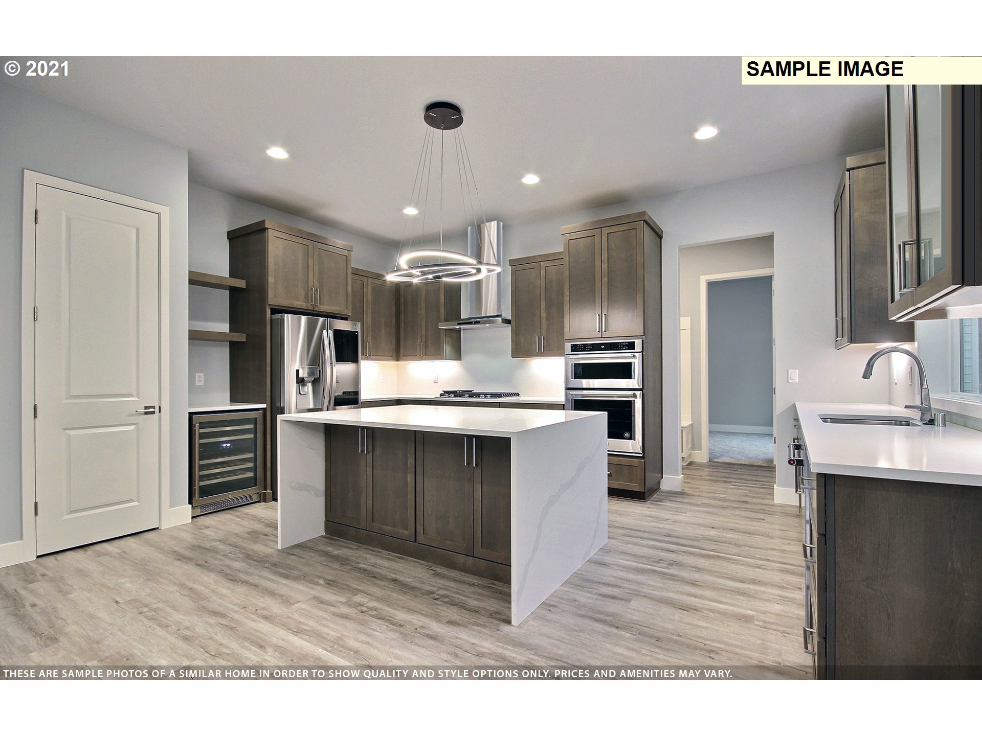 3338 Northwest Tanner Street Camas, WA 98607 - Photo 9 of 25 a kitchen with stainless steel appliances kitchen island granite countertop a refrigerator and a sink