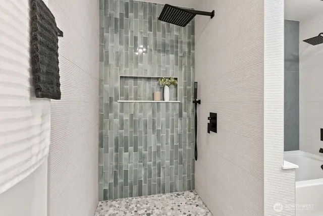 a bathroom with a shower and a sink