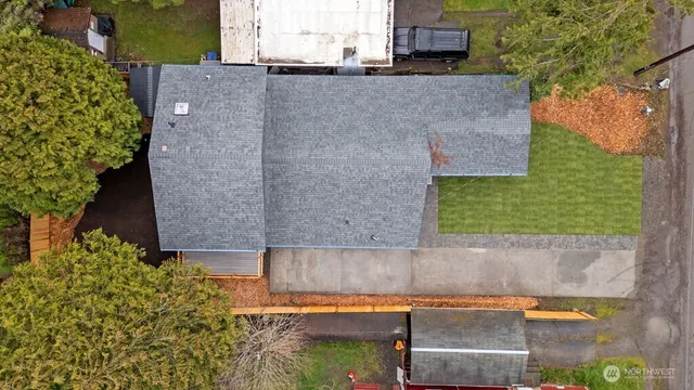 an aerial view of a house with a yard