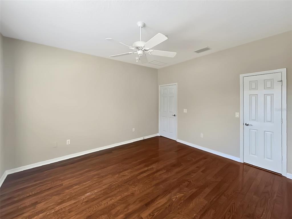 4203 Overture Circle Bradenton, FL 34209 - Photo 13 of 25 a view of an empty room with wooden floor