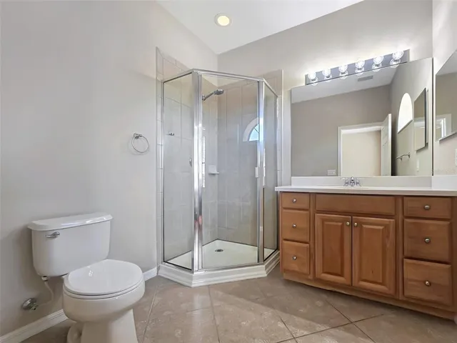 a bathroom with a toilet a sink and shower