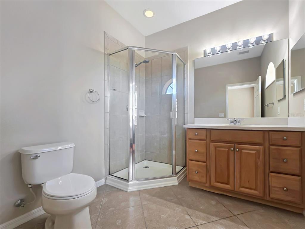 4203 Overture Circle Bradenton, FL 34209 - Photo 14 of 25 a bathroom with a toilet a sink and shower