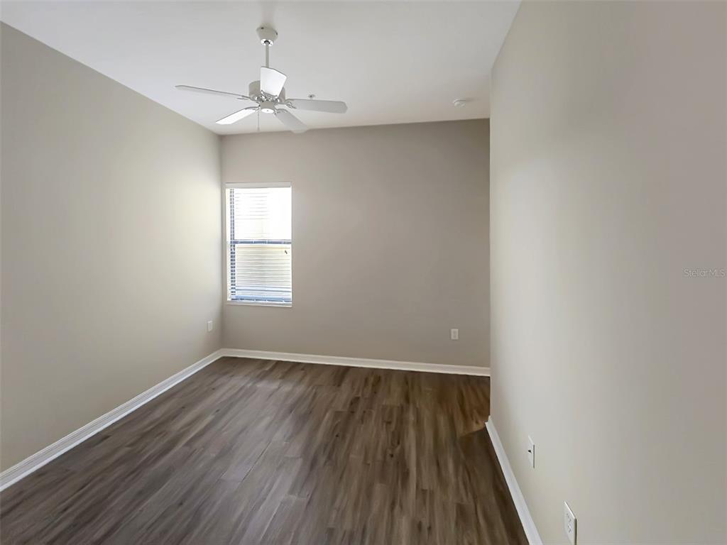 4203 Overture Circle Bradenton, FL 34209 - Photo 17 of 25 wooden floor in an empty room with a window