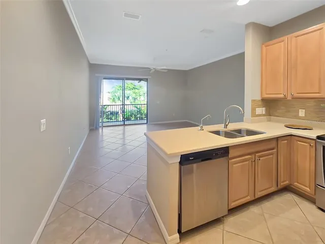 a kitchen with a sink cabinets and window