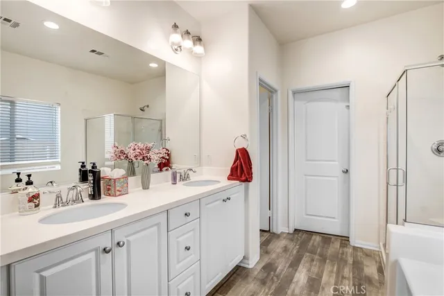 a bathroom with a double vanity sink mirror and