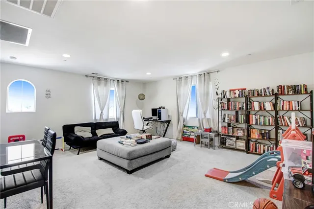 a living room with furniture gym equipment and a chandelier