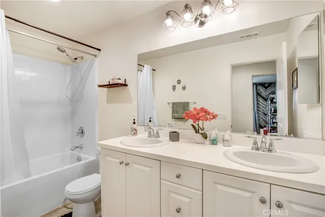 a bathroom with a double vanity sink mirror double and bathtub
