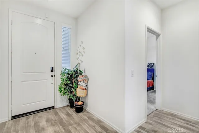 a view of an entryway with wooden floor