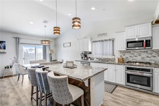 a kitchen with a dining table chairs and a fireplace