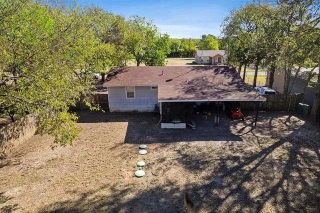 a view of a house with a yard and tree