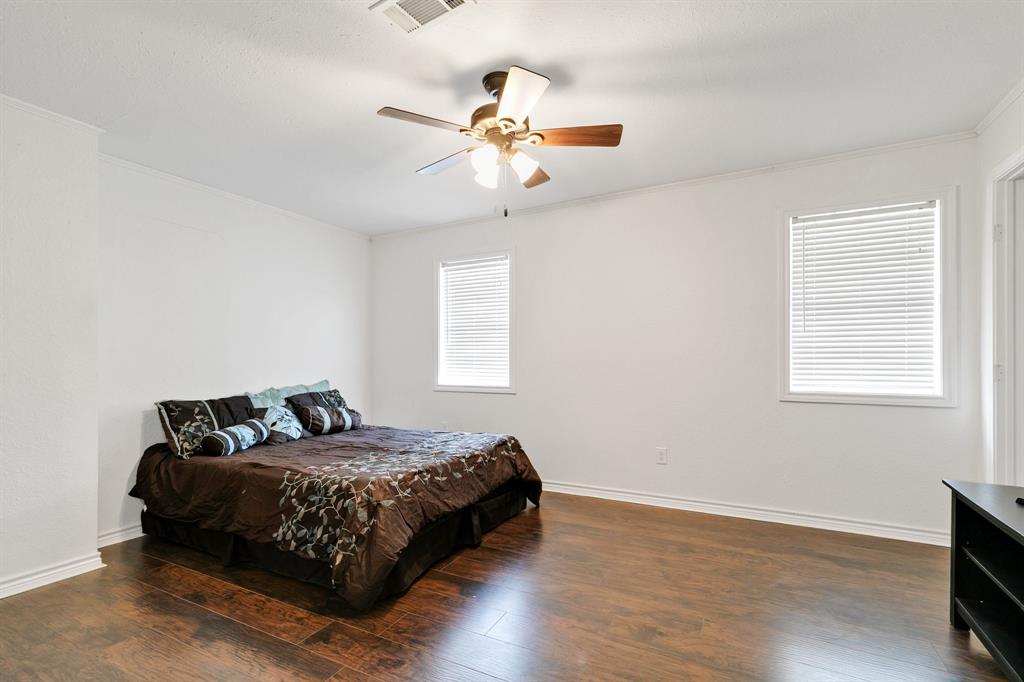 1325 Pilot Grove Road Whitewright, TX 75491 - Photo 18 of 30 Bedroom with dark wood flooring, ceiling fan, and a closet.