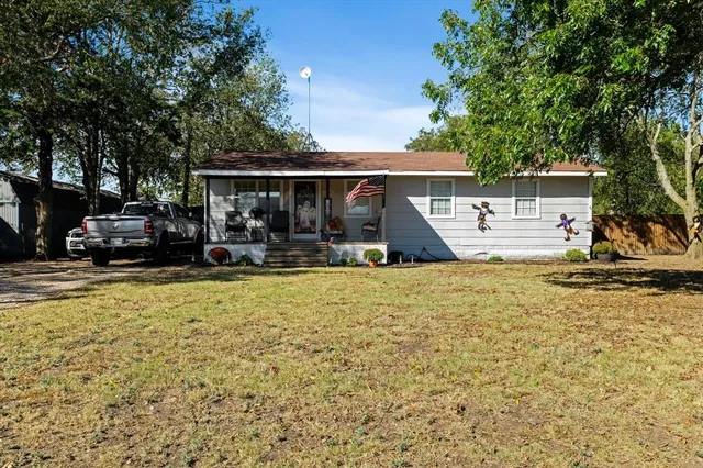 a front view of a house with a yard patio and fire pit