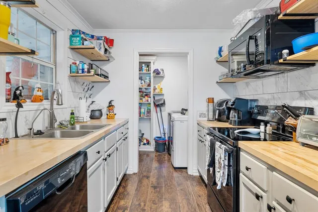 a kitchen with stainless steel appliances granite countertop a stove and cabinets