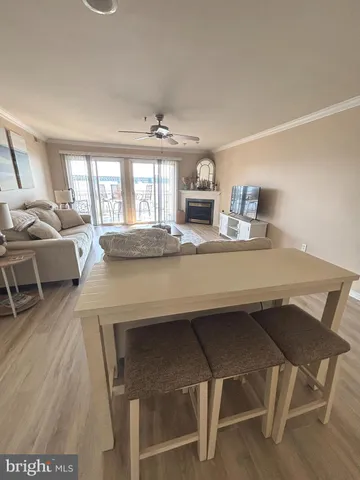 a dining hall with stainless steel appliances granite countertop furniture and wooden floor