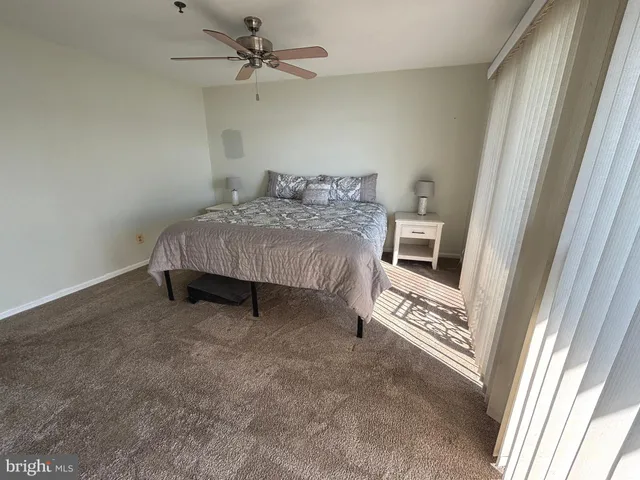 a large bedroom with a bed and a window