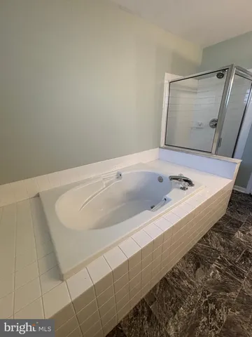 a bathroom with a glass door shower and a mirror