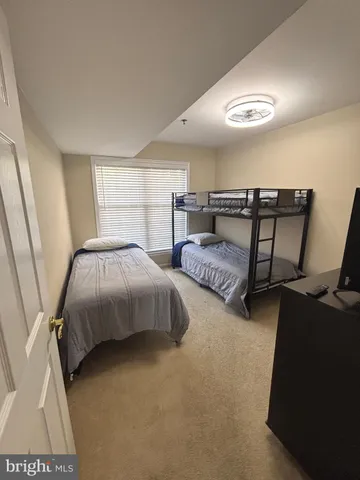 a bathroom with a sink a toilet a mirror and shower