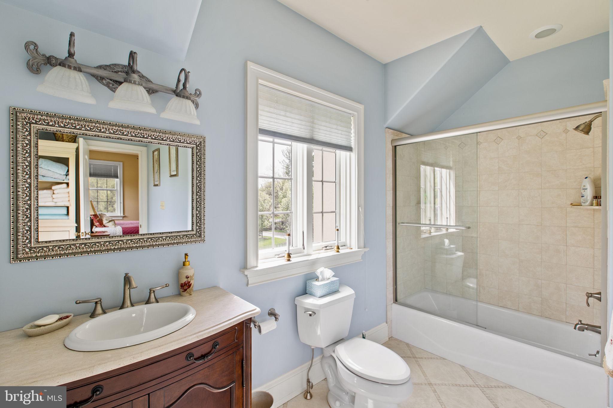 1519 Cedar Hill Road Lower Gwynedd, PA 19002 - Photo 53 of 95 a bathroom with a granite countertop sink toilet a large mirror and shower