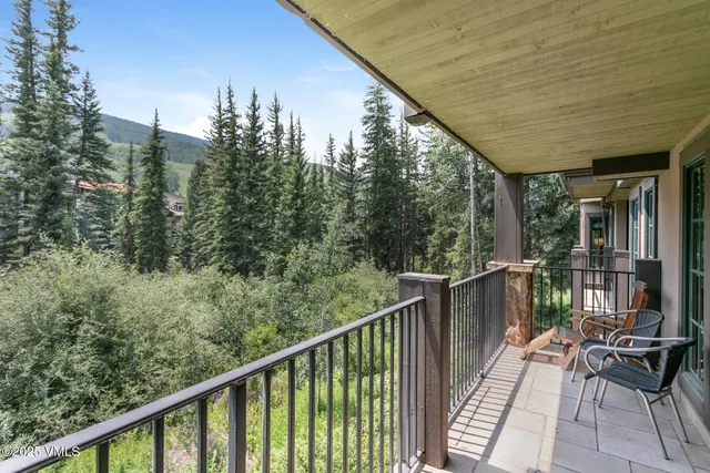 a balcony with wooden floor and outdoor space