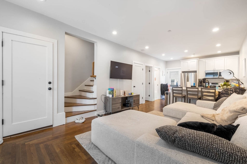 a large bedroom with bed tv and couches