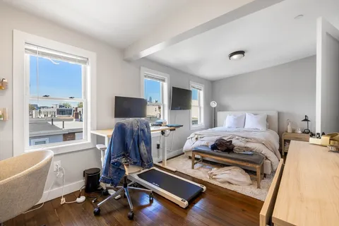a bedroom with furniture and a window