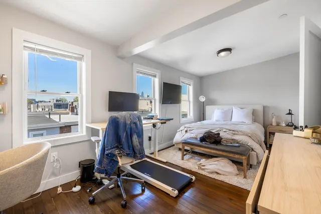 a bedroom with furniture and a window