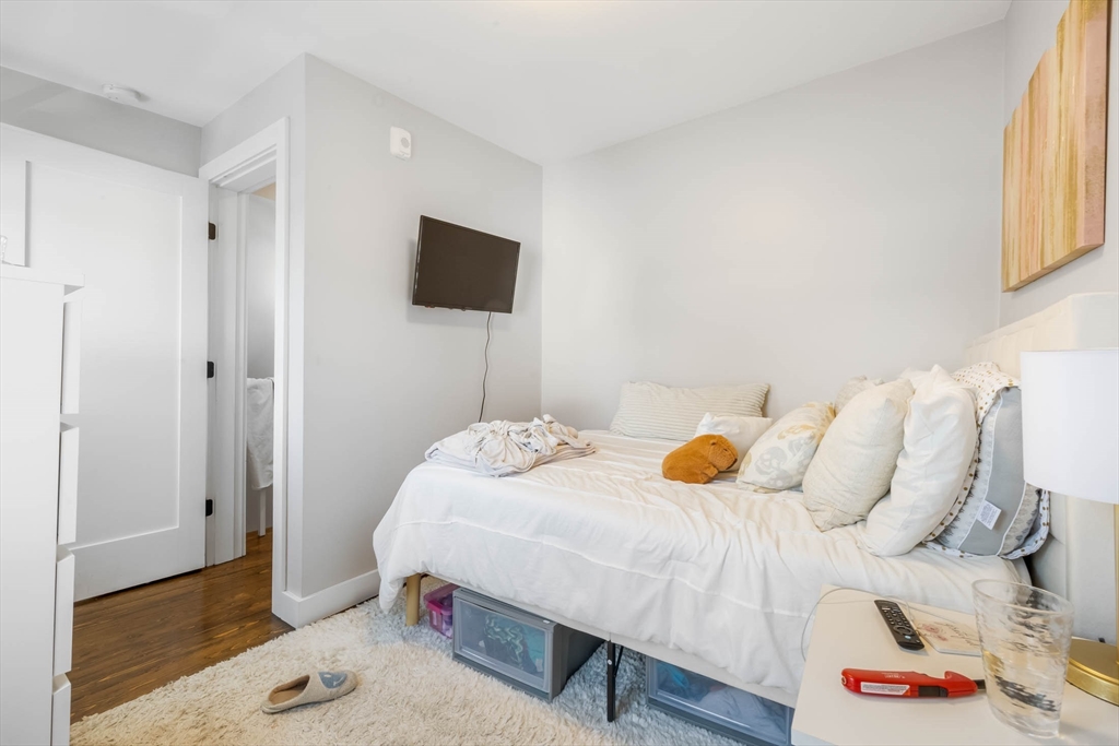 20 Grimes Street, Unit SF Boston, MA 02127 - Photo 12 of 15 a bedroom with a bed and a tv