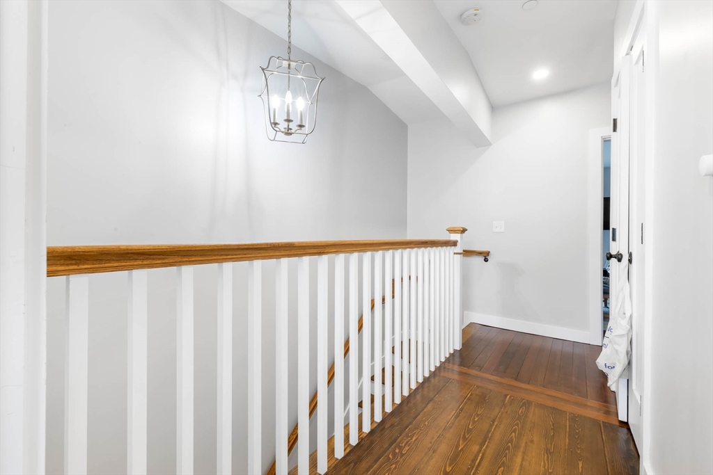 20 Grimes Street, Unit SF Boston, MA 02127 - Photo 13 of 15 a view of a hallway with wooden floor and staircase