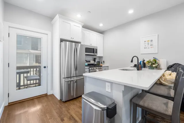 a kitchen with stainless steel appliances a stove refrigerator sink and cabinets