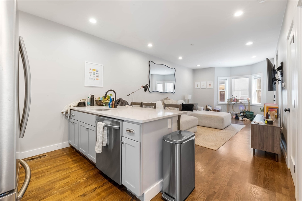20 Grimes Street, Unit SF Boston, MA 02127 - Photo 4 of 15 a kitchen with stainless steel appliances granite countertop a sink stove and refrigerator