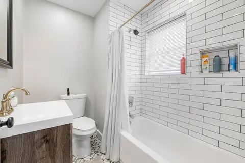 a bathroom with a toilet and a bathtub