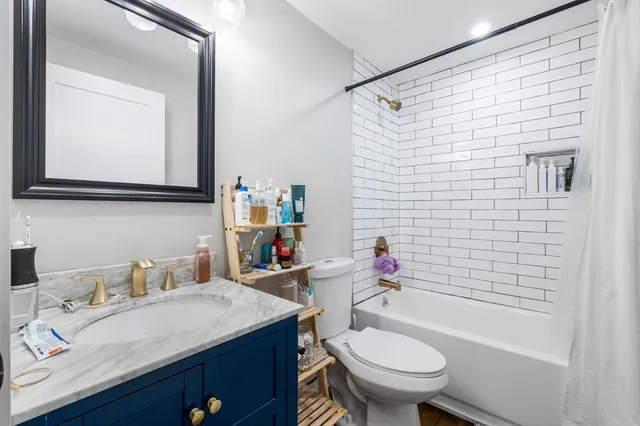 a bathroom with a sink toilet and shower