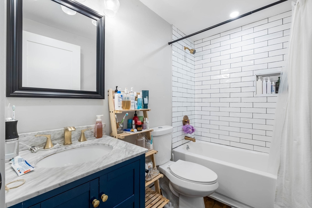 20 Grimes Street, Unit SF Boston, MA 02127 - Photo 9 of 15 a bathroom with a sink toilet and shower