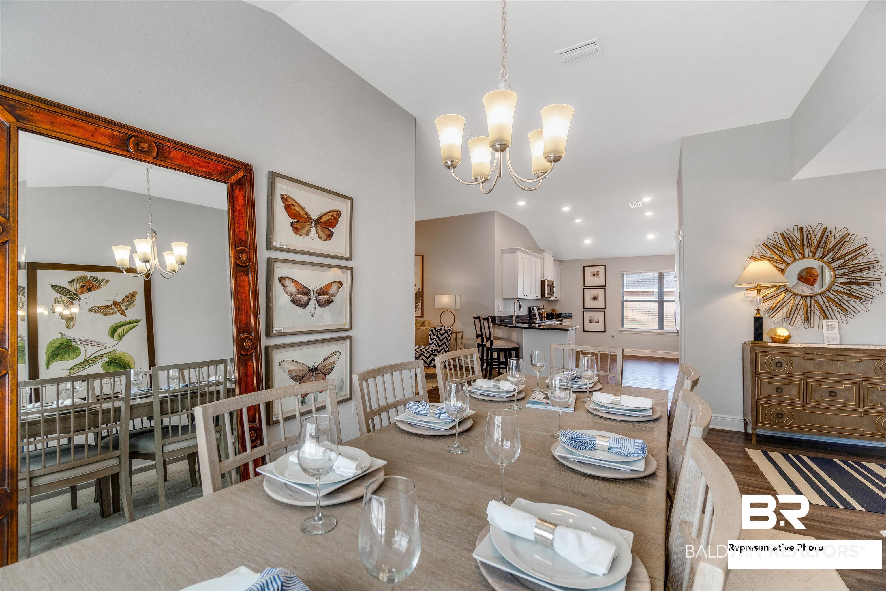643 Mayflower Drive Foley, AL 36535 - Photo 12 of 34 Dining room with vaulted ceiling, visible vents, a notable chandelier, and wood finished floors