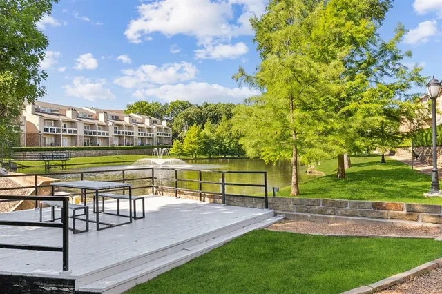 a view of a swimming pool with a garden and trees