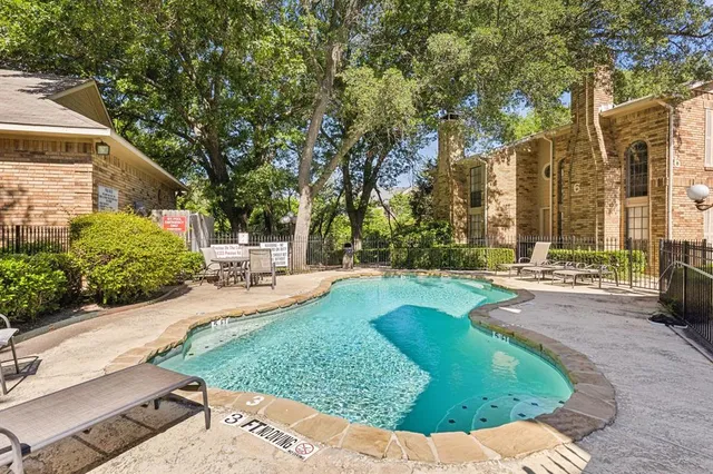 a view of a backyard with sitting area