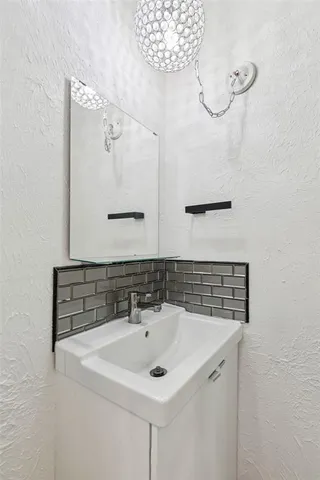 a bathroom with a sink and mirror