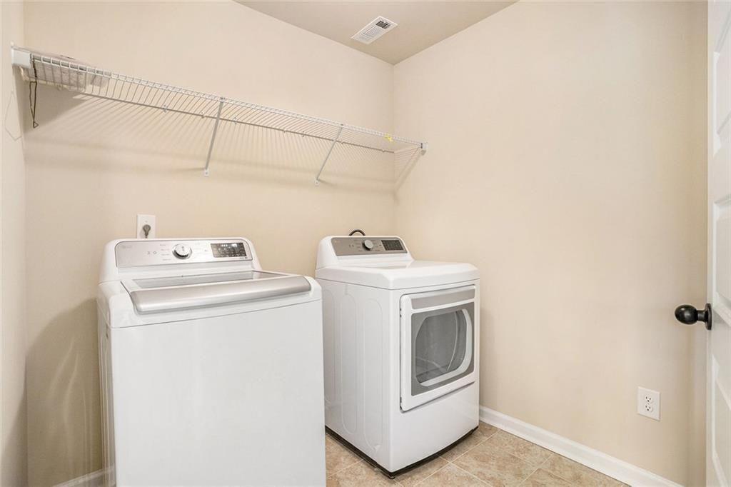 381 Homestead Circle Forsyth, GA 31029 - Photo 19 of 49 a utility room with dryer and washer