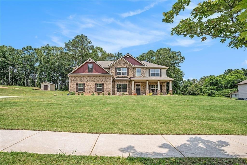 381 Homestead Circle Forsyth, GA 31029 - Photo 3 of 49 a front view of a house with a garden