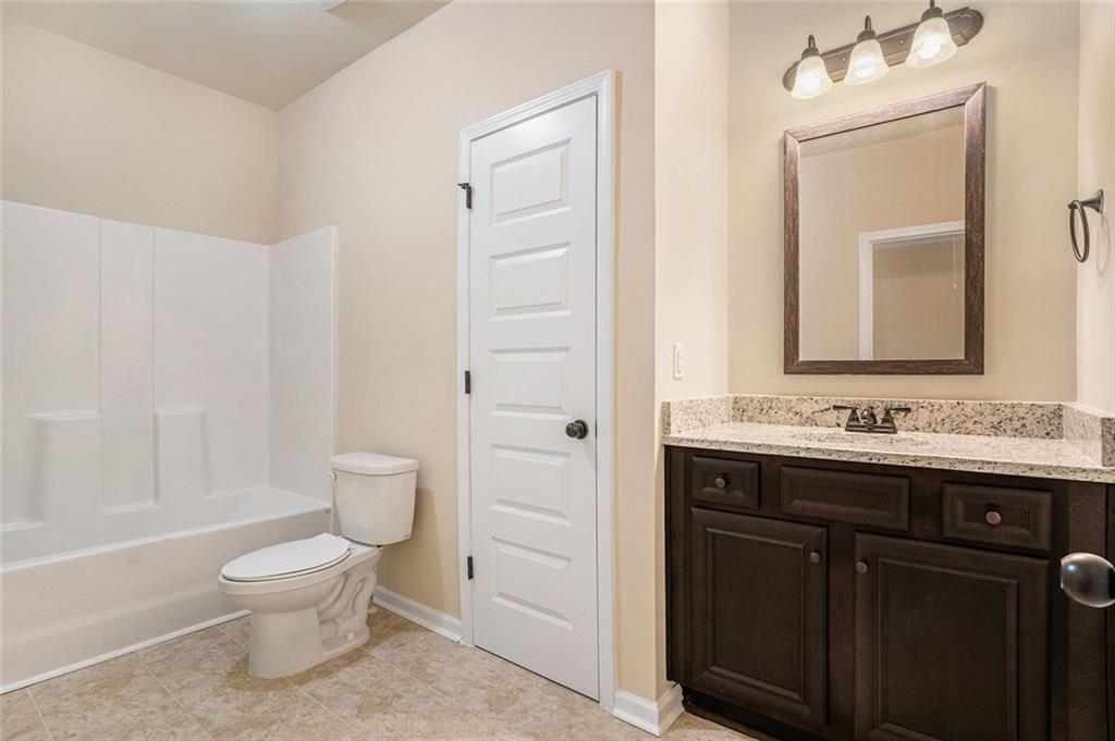 381 Homestead Circle Forsyth, GA 31029 - Photo 33 of 49 a bathroom with a toilet a sink and a mirror