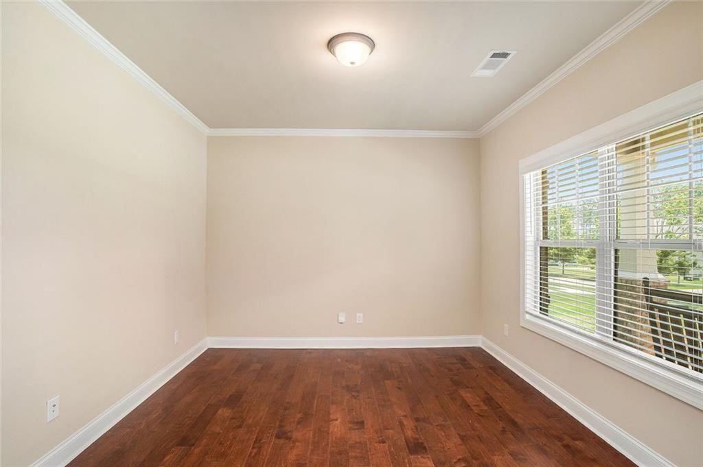 381 Homestead Circle Forsyth, GA 31029 - Photo 5 of 49 an empty room with wooden floor and windows