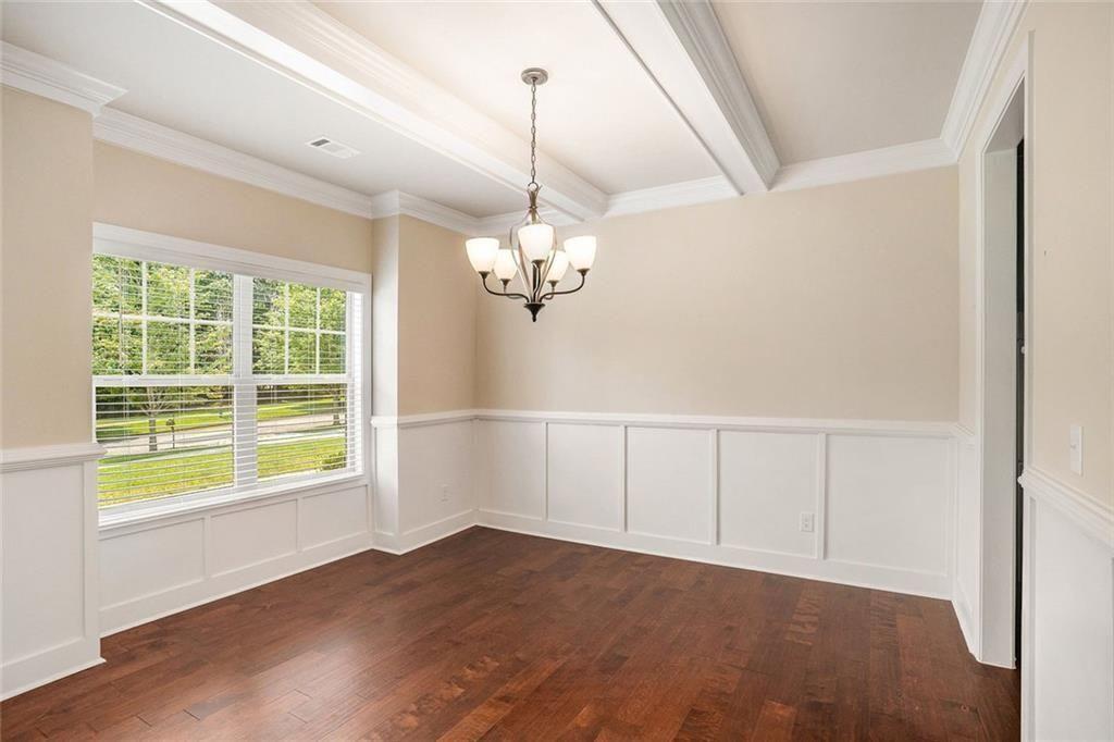 381 Homestead Circle Forsyth, GA 31029 - Photo 7 of 49 a view of an empty room with a window and wooden floor