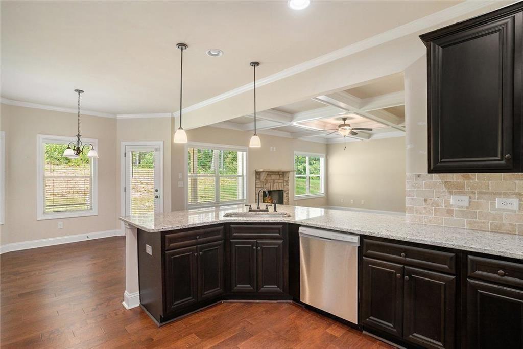 381 Homestead Circle Forsyth, GA 31029 - Photo 10 of 49 a kitchen with a sink stove and wooden floor