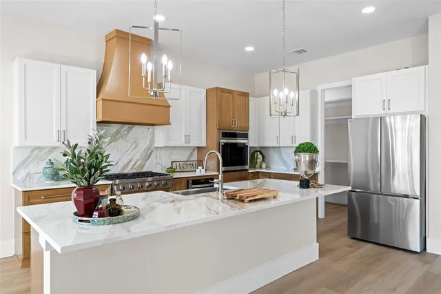 a kitchen with a refrigerator and a sink