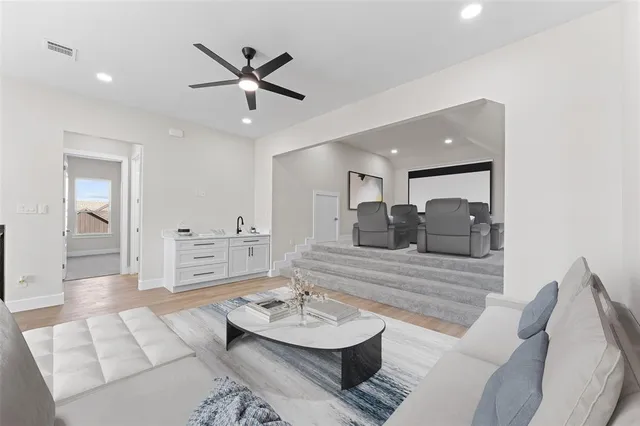 a living room with furniture and a wooden floor