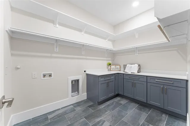 a kitchen with cabinets and window
